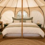 Luxury glamping tent interior with hotel-style bedding